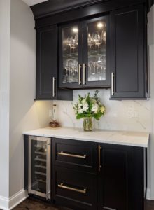 Black cabinets with gold fixtures in quality kitchen remodel