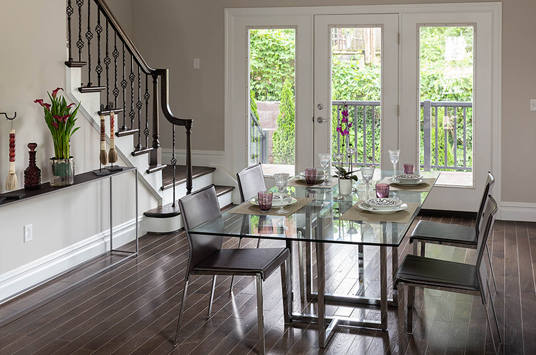 House with dark wood flooring and a glass dining room table